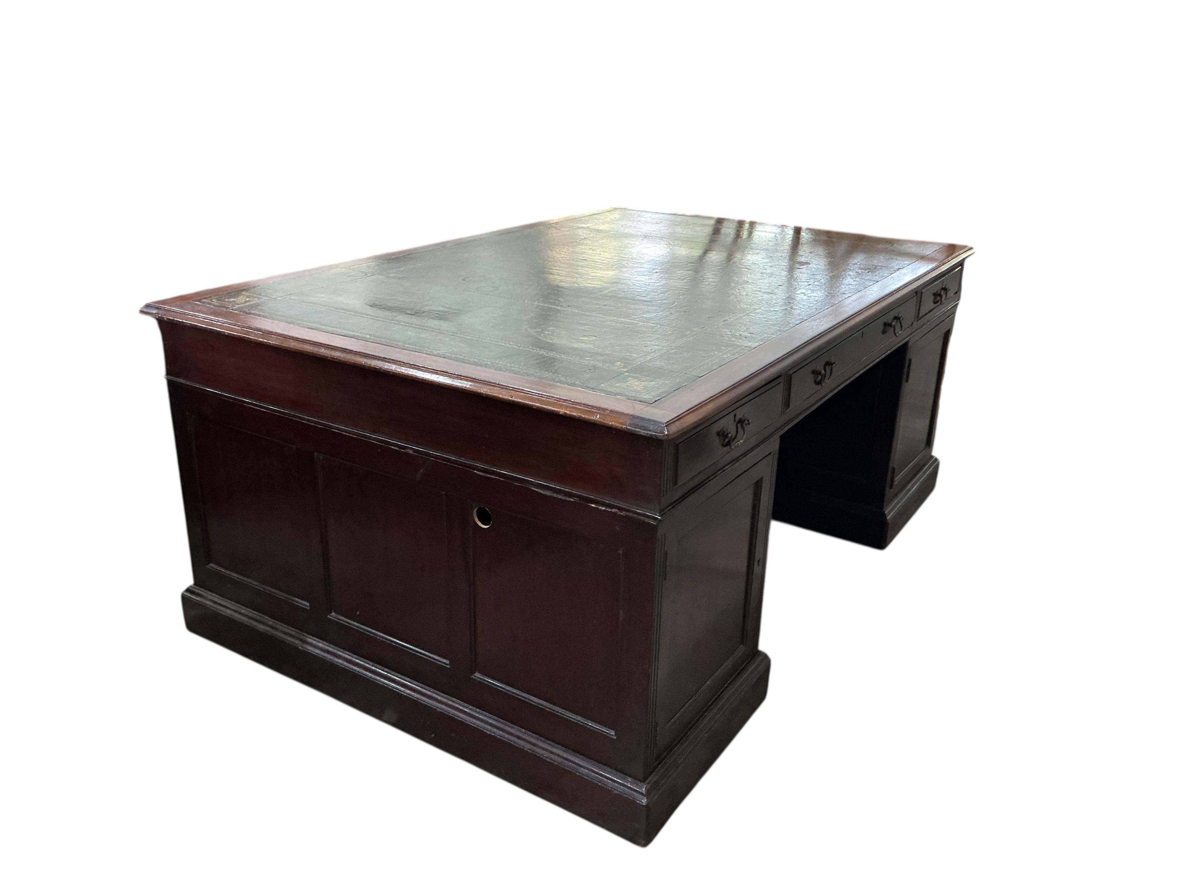 A reproduction George III style mahogany pedestal partners desk, width 180cm, depth 120cm, height 76cm, together with a button green leather swivel desk chair